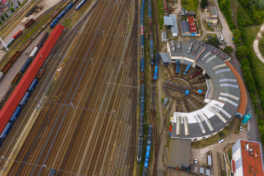 Aerial view of a railway roundhouse with a central turntable and multiple trains parked on tracks in Breclav South Moravian Region Czechia.