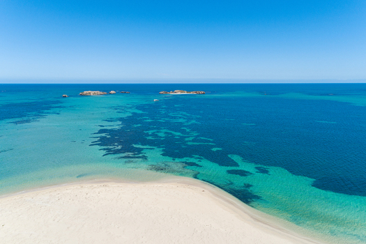 Aerial view of the pristine white sand beach meeting the turquoise and deep blue waters of the Indian Ocean near Perth Western Australia Australia. Aerial view of the pristine white sand beach meeting the turquoise and deep blue waters of the Indian Ocean near Perth Western Australia Australia.