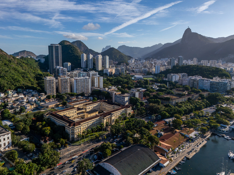 Aerial view of Botafogo featuring the historic Palacio da Cidade surrounding high rise buildings lush green hills and the bay in Rio de Janeiro Rio de Janeiro Brazil.