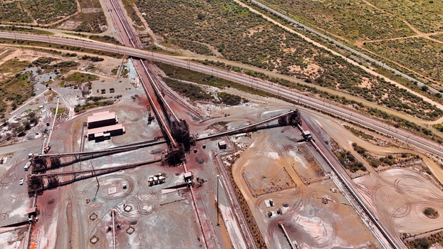 Aerial view of sprawling industrial complex with its stark rust colored earth contrasting against the sparse greenery Rustenburg North West South Africa. Aerial view of sprawling industrial complex with its stark rust colored earth contrasting against the sparse greenery Rustenburg North West South Africa.