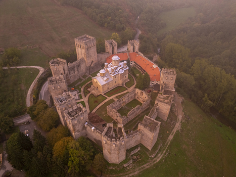 Aerial view of Manasija Monastery with its fortified stone walls towers and central church surrounded by lush green landscape in Despotovac Pomoravski okrug Serbia.