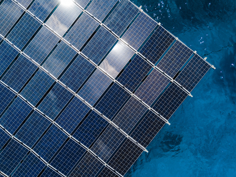 Aerial view of SolarSea floating solar power plant by Swimsol with sunlight reflecting on the panels over deep blue water Dharavandhoo Baa Atoll Maldives. Aerial view of SolarSea floating solar power plant by Swimsol with sunlight reflecting on the panels over deep blue water Dharavandhoo Baa Atoll Maldives.