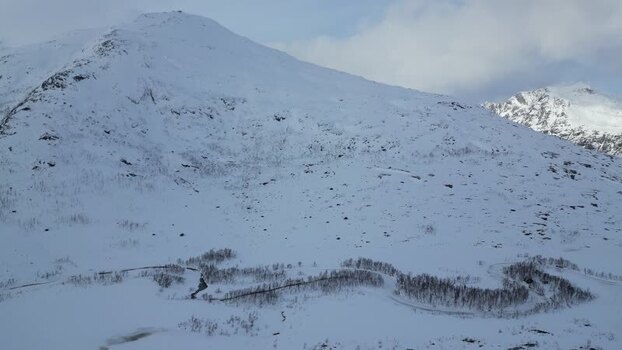 Aerial view of snow covered mountains on Kvaloya island Norway.