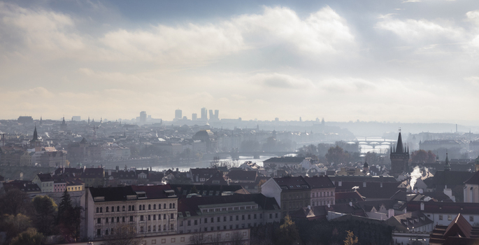 View of the historic Prague skyline featuring the Vltava river Charles Bridge towers and traditional red rooftops under a cloudy sky in Prague Prague Czechia. View of the historic Prague skyline featuring the Vltava river Charles Bridge towers and traditional red rooftops under a cloudy sky in Prague Prague Czechia.