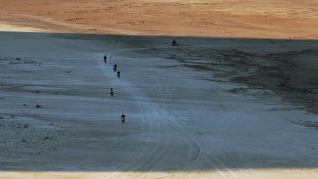 Aerial view of motorcyclists riding through the desert Kazakhstan. Aerial view of motorcyclists riding through the desert Kazakhstan.