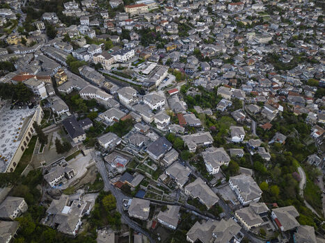 Aerial view of the historic stone houses and slate roofs of Gjirokaster in Gjirokaster County Albania. Aerial view of the historic stone houses and slate roofs of Gjirokaster in Gjirokaster County Albania.