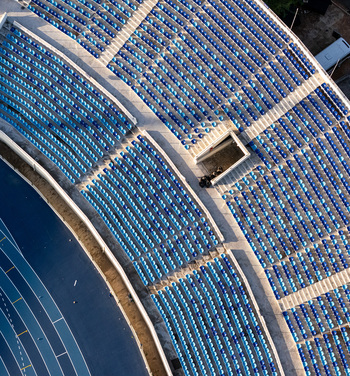 Aerial view of stadium seating with rows of blue chairs and a running track in Santo Domingo Distrito Nacional Dominican Republic.