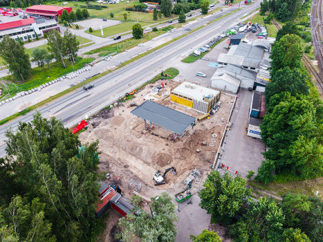 Riga Latvia 04 July 2026 Aerial view of a new gas station under construction in the Zemgale Suburb featuring a canopy structure heavy machinery and surrounding industrial infrastructure.