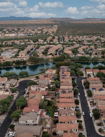 Aerial view of homes around Sahuarita Lake in Sahuarita Arizona showing a lakeside desert neighborhood with walking paths and mountain views.