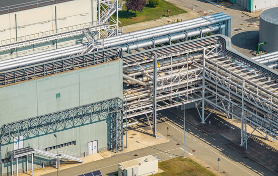 Aerial view of dense industrial pipe racks and utility pipelines at a modern power generation facility in Chivasso Piedmont Italy. Aerial view of dense industrial pipe racks and utility pipelines at a modern power generation facility in Chivasso Piedmont Italy.