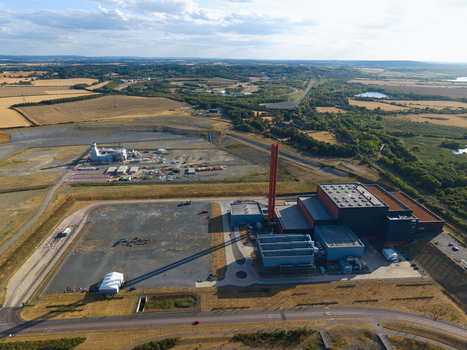 Aerial view of Rookery South ERF a large industrial facility with a tall chimney surrounded by open fields and rural landscape in Stewartby England United Kingdom. Aerial view of Rookery South ERF a large industrial facility with a tall chimney surrounded by open fields and rural landscape in Stewartby England United Kingdom.