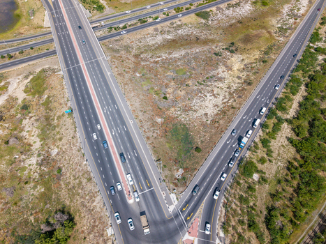 Aerial view of the highway interchange in Milnerton with multi lane roads and traffic flowing through the landscape in Cape Town Western Cape South Africa. Aerial view of the highway interchange in Milnerton with multi lane roads and traffic flowing through the landscape in Cape Town Western Cape South Africa.