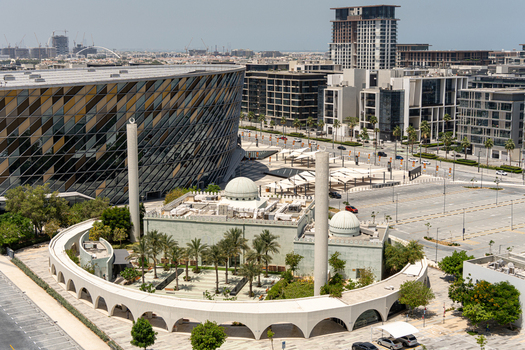 Aerial view of a modern mosque with two minarets and palm trees situated next to the circular Coca Cola Arena in the City Walk district Dubai Dubai United Arab Emirates. Aerial view of a modern mosque with two minarets and palm trees situated next to the circular Coca Cola Arena in the City Walk district Dubai Dubai United Arab Emirates.
