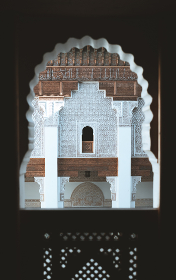 View of ornate traditional architecture with intricate mosaic windows and arches Marrakech Morocco.