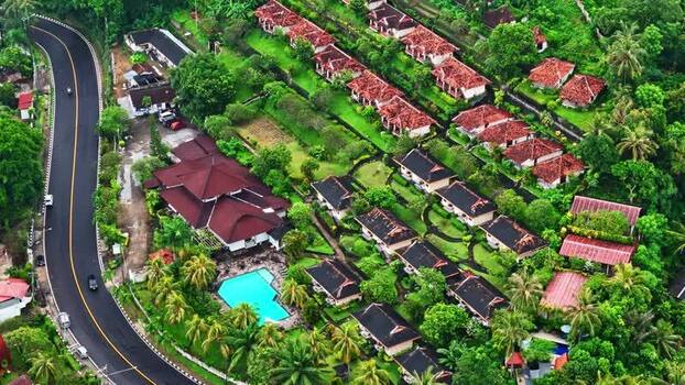 Aerial view of resort villas and winding road in Bali Indonesia.