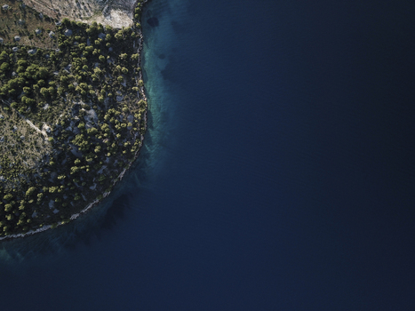 Aerial view of Azure Adriatic Coastline with Pine Forests on Brac Island Croatia.