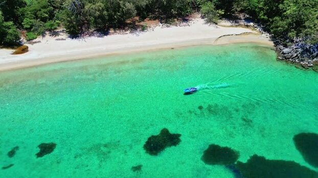 Aerial view of a boat in turquoise waters of Guanaja Honduras. Aerial view of a boat in turquoise waters of Guanaja Honduras.
