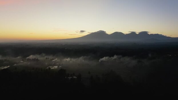 Aerial view of volcanic mountains and misty valley at sunrise Indonesia. Aerial view of volcanic mountains and misty valley at sunrise Indonesia.