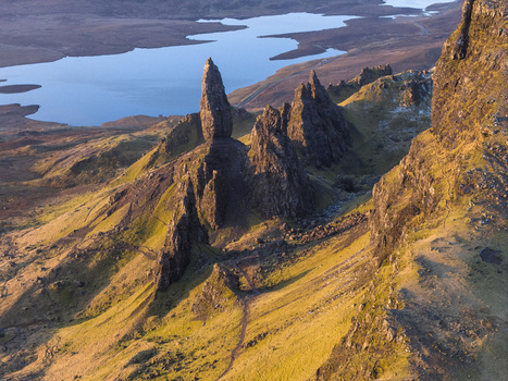 Aerial view of The Storr rocky pinnacles and the Old Man of Storr overlooking Loch Leathan during golden hour Isle of Skye Scotland United Kingdom. Aerial view of The Storr rocky pinnacles and the Old Man of Storr overlooking Loch Leathan during golden hour Isle of Skye Scotland United Kingdom.
