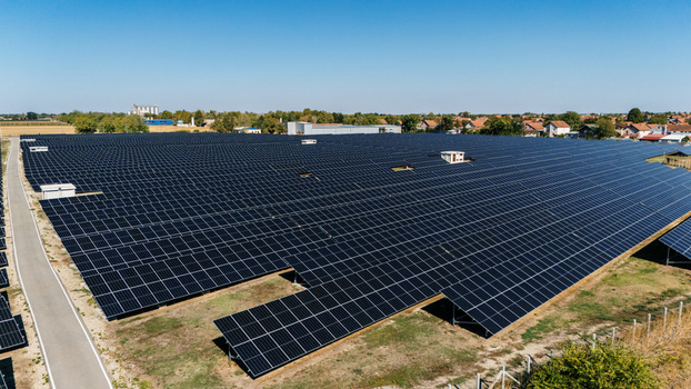 Aerial view of a large solar farm with rows of photovoltaic panels in a rural landscape under a clear blue sky in Temerin Vojvodina Serbia. Aerial view of a large solar farm with rows of photovoltaic panels in a rural landscape under a clear blue sky in Temerin Vojvodina Serbia.