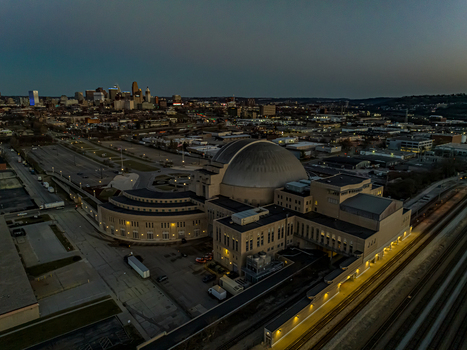 Aerial view of the iconic Union Terminal glows softly against the dimming twilight a beacon of art deco architecture and transit history Cincinnati Ohio United States. Aerial view of the iconic Union Terminal glows softly against the dimming twilight a beacon of art deco architecture and transit history Cincinnati Ohio United States.