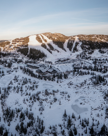 Aerial view of Gaustablikk Fjellresort nestled in the snowy mountains with ski slopes pine forests and frozen ponds in Rjukan Telemark Norway. Aerial view of Gaustablikk Fjellresort nestled in the snowy mountains with ski slopes pine forests and frozen ponds in Rjukan Telemark Norway.