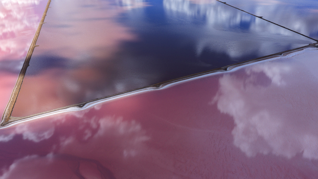 Aerial view of vibrant pink and deep blue salt evaporation ponds with geometric industrial patterns reflecting clouds in Kalbarri Western Australia Australia. Aerial view of vibrant pink and deep blue salt evaporation ponds with geometric industrial patterns reflecting clouds in Kalbarri Western Australia Australia.