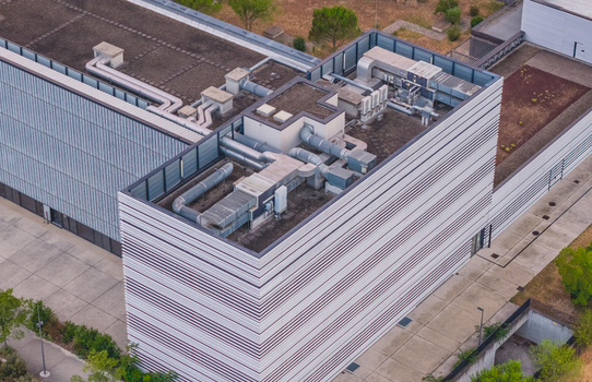 Aerial view of the Ecotox scientific campus rooftop featuring modern ventilation ducts air handling units and mechanical building systems in Alixan Auvergne Rhone Alpes France.
