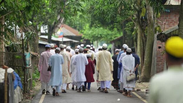 View of men in traditional attire walking on a village road Bangladesh. View of men in traditional attire walking on a village road Bangladesh.