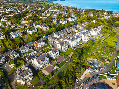 Aerial view of Bangor Harbour and Town featuring residential buildings lush green spaces and coastal scenery in Bangor Northern Ireland United Kingdom.
