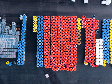 Aerial view of rows of colorful polymer pipe rolls stored in an industrial yard showcasing advanced manufacturing and infrastructure components in Jelgava Latvia. Aerial view of rows of colorful polymer pipe rolls stored in an industrial yard showcasing advanced manufacturing and infrastructure components in Jelgava Latvia.