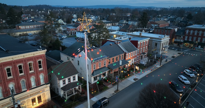 Aerial view of Manheim Square decorated with festive Christmas lights at dawn featuring historic buildings and quiet streets in Manheim Pennsylvania United States. Aerial view of Manheim Square decorated with festive Christmas lights at dawn featuring historic buildings and quiet streets in Manheim Pennsylvania United States.