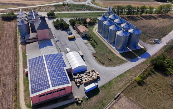 Aerial view of storage silo Bavaniste with solar panels on the warehouse roof trucks and surrounding agricultural fields in Bavaniste Vojvodina Serbia.