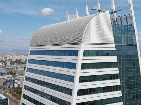 Aerial view of the modern Capital Fort skyscraper with its distinctive curved roof and glass facade rising above the urban landscape in Sofia Sofia City Province Bulgaria. Aerial view of the modern Capital Fort skyscraper with its distinctive curved roof and glass facade rising above the urban landscape in Sofia Sofia City Province Bulgaria.