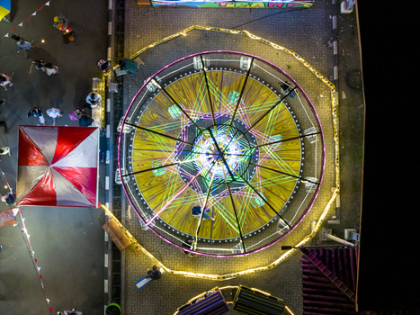 Aerial view of the GOR Gelarsena Klaten Night Market with a brightly lit spinning amusement ride and colorful neon lights at night in Kecamatan Klaten Utara Jawa Tengah Indonesia. Aerial view of the GOR Gelarsena Klaten Night Market with a brightly lit spinning amusement ride and colorful neon lights at night in Kecamatan Klaten Utara Jawa Tengah Indonesia.
