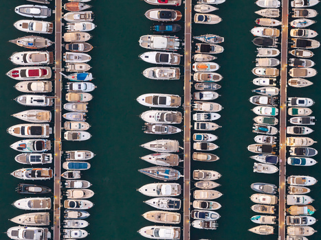 Aerial view of numerous yachts and motorboats docked in neat rows at the marina in Antibes Provence Alpes Cote d Azur France. Aerial view of numerous yachts and motorboats docked in neat rows at the marina in Antibes Provence Alpes Cote d Azur France.
