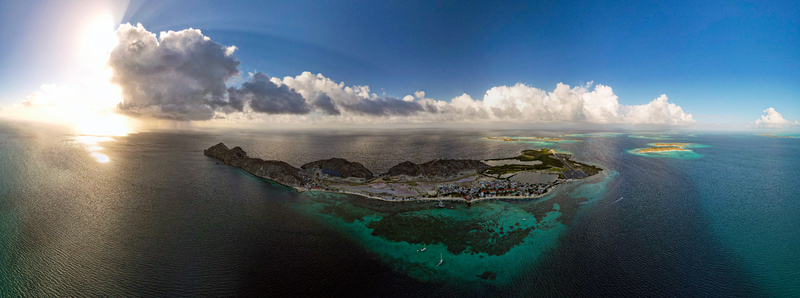 Aerial view of Los Roques archipelago featuring turquoise waters coral reefs and small islands under a bright sun in Los Roques Dependencias Federale Venezuela. Aerial view of Los Roques archipelago featuring turquoise waters coral reefs and small islands under a bright sun in Los Roques Dependencias Federale Venezuela.
