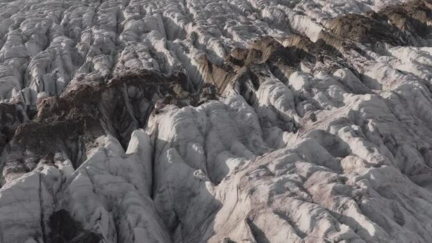 Aerial view of Aletsch Glacier with deep ice crevasses Switzerland.