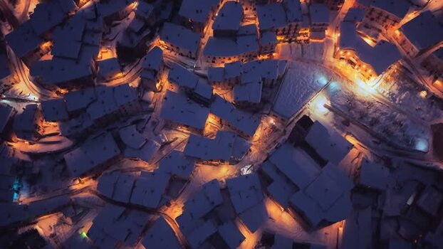 Aerial view of snow covered Rivisondoli at night Italy.