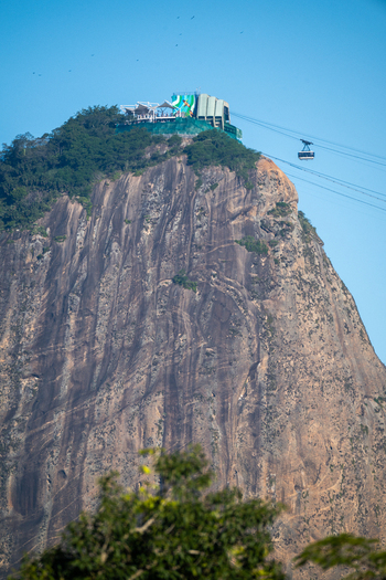 View of Sugarloaf Mountain with its iconic granite peak and cable car system against a clear blue sky in Rio de Janeiro Rio de Janeiro Brazil. View of Sugarloaf Mountain with its iconic granite peak and cable car system against a clear blue sky in Rio de Janeiro Rio de Janeiro Brazil.