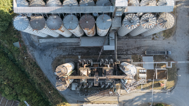Aerial view of industrial grain silos and processing facility with metal storage tanks and pipes in Sremska Mitrovica Vojvodina Serbia. Aerial view of industrial grain silos and processing facility with metal storage tanks and pipes in Sremska Mitrovica Vojvodina Serbia.