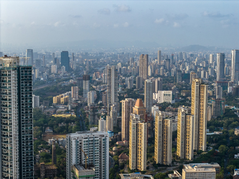 Aerial view of the dense high rise skyline and urban landscape of Mumbai featuring numerous skyscrapers residential towers and green spaces in Mumbai Maharashtra India. Aerial view of the dense high rise skyline and urban landscape of Mumbai featuring numerous skyscrapers residential towers and green spaces in Mumbai Maharashtra India.