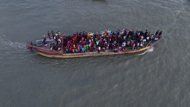 Aerial view of a crowded boat with people on a river Bangladesh.