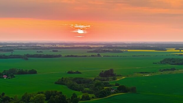 Aerial view of sunset over the green countryside of Latvia. Aerial view of sunset over the green countryside of Latvia.