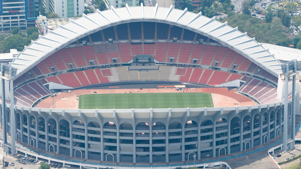 Aerial view of Rajamangala National Stadium with its distinctive arched roof red seating and central green pitch in Krung Thep Maha Nakhon Thailand. Aerial view of Rajamangala National Stadium with its distinctive arched roof red seating and central green pitch in Krung Thep Maha Nakhon Thailand.