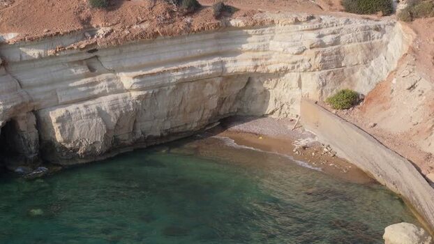 Aerial view of coastal cliffs and turquoise waters in Cyprus.