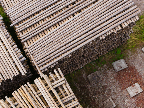 Aerial view of stacked timber logs arranged in neat rows at a lumber yard in Brankas Jelgava Municipality Latvia. Aerial view of stacked timber logs arranged in neat rows at a lumber yard in Brankas Jelgava Municipality Latvia.