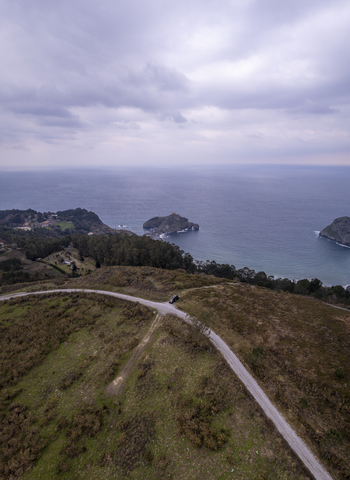 Aerial view of the islet of San Juan de Gaztelugatxe with its winding stone path and church surrounded by the Cantabrian Sea and cliffs in Gaztelugatxeko Doniene Euskadi Spain. Aerial view of the islet of San Juan de Gaztelugatxe with its winding stone path and church surrounded by the Cantabrian Sea and cliffs in Gaztelugatxeko Doniene Euskadi Spain.