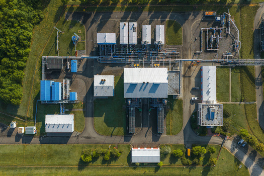 Aerial view of the UGS Damborice industrial facility with white and blue buildings complex piping systems and asphalt roads in Damborice South Moravian Region Czechia. Aerial view of the UGS Damborice industrial facility with white and blue buildings complex piping systems and asphalt roads in Damborice South Moravian Region Czechia.