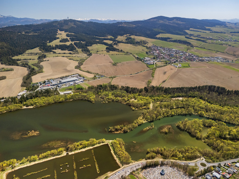 Aerial view of Oravska priehrada reservoir surrounded by lush green forests rolling fields and the town of Namestovo under a clear blue sky Namestovo Zilinsky kraj Slovakia. Aerial view of Oravska priehrada reservoir surrounded by lush green forests rolling fields and the town of Namestovo under a clear blue sky Namestovo Zilinsky kraj Slovakia.